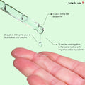 A close up photo of the texture of the B-Bomb serum, as a droplet comes out of the pipette, into a palm of a hand.  The text on the image explains how to use the product: use it in the AM and/or PM. Apply 3-4 drops to your face before your creams. Can be used together in the same routine with any other active ingredient.